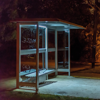 photograph of an empty bus stop late at night
